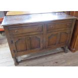 An oak sideboard, fitted two drawers over a pair of cupboard doors, 54ins x 21ins, height 36ins