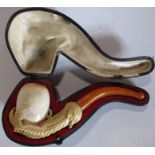 A cased meerschaum pipe, carved as a dragons claw holding an egg