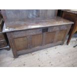An antique coffer, the rising lid over four fielded panels, width 51ins x depth 21ins x height 24.