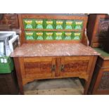 An Arts and Crafts style wash stand, with tiled back over marble top