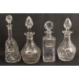 Four various glass decanters, with stoppers, together with four hallmarked silver bottle tickets,