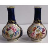 A pair 19th century Derby porcelain bottle vases, decorated with reserves of flowers to a dark