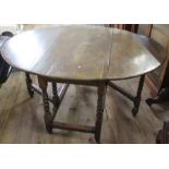 An oak gateleg table, raised on barley twist supports, 48ins x 58ins, height 29ins