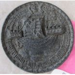 A circular seal, decorated with a ship