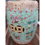 An Oriental garden seat, formed as a barrel, decorated with flowers to a turquoise ground, with