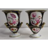 A pair 19th century Derby porcelain campagna urns, decorated with reserves of flowers to a dark blue