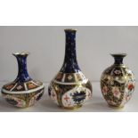 Three Royal Crown Derby Imari pattern vases, height 6.25ins and down