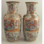 A pair of 19th century Cantonese vases, decorated with panels of figures, and all around in
