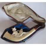 A cased meerschaum pipe, carved as a reclining male figure