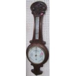 An oak cased banjo barometer, with carved decoration, height 35ins