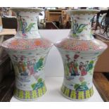 A pair of Oriental vases, decorated with figures, height 16.5ins