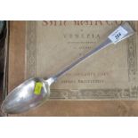 A Georgian silver fiddle pattern serving spoon, engraved with a crest, London 1810, weight 4oz