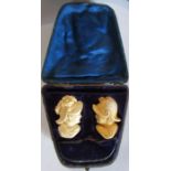 A cased pair of Meerschaum pipe bowls, carved as a man and a woman