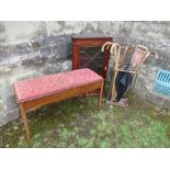 A mahogany corner cupboard, piano stool, brass stick stand and contents