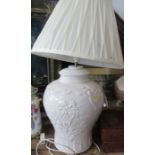 A white pottery lamp base, with embossed decoration, height including shade 26ins