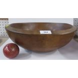 A turned wooden dairy bowl, diameter 13.5ins, height 4.5ins, together with a painted ball