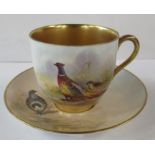 A Royal Worcester cabinet cup and saucer, the cup decorated with a Pheasant and the saucer with a