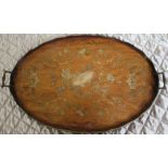 A 19th century oval mahogany tray, shaped gallery edge, decorated with musical instruments, swags