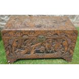 An Eastern carved blanket box, decorated with figures in landscape and flowers, 41ins x 20.5ins,