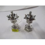 A pair of novelty silver condiment pots, formed as Oriental buildings, marked Sterling