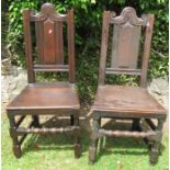 A pair of Antique oak hall chairs, with carved backs and solid seats
