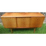 A 20th century Gold Key Alfred Cox sideboard, fitted with a cupboard door revealing drawers and a