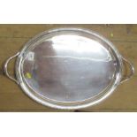 A silver oval tray, with gadrooned edge and handles, Birmingham 1923, diameter across handles 24ins,