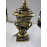 A 19th century Wedgwood covered urn, decorated in gilt on a dark blue ground, af, height 8ins