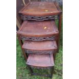 A nest of four Eastern hardwood tables, with pierced apron, 19ins x 14ins, height 27.5ins of the