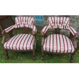 A pair of Edwardian low chairs, with carved decoration