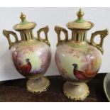 A pair of Crown Devon covered vases, decorated with pheasants, signed J Coleman, height 9.5ins -
