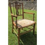 An Edwardian single salon chair, with carved decoration