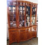 A reproduction yew wood breakfront cabinet, with glazed upper section, fitted with cupboards,