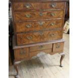 An Antique walnut veneered chest of stand, fitted with two short over three long graduated