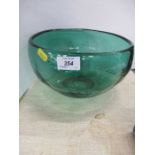 In the style of Geoffrey Baxter, a green glass bowl etched with fish and reeds, diameter 9.5ins,