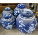 Two pairs of Oriental blue and white covered ginger jars, height 6.5ins and 5ins