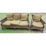 A mahogany bergere suite, comprising settee and armchair, with carved decoration,