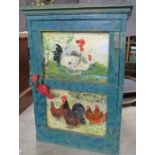 A painted cupboard, decorated with chickens