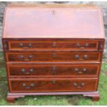 A Georgian mahogany bureau, the fitted interior having secret compartment flanked by pigeonholes,