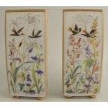 A pair of 19th century rectangular milk glass vases, decorated with birds and foliage, raised on