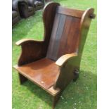 An oak lambing chair, with wing back