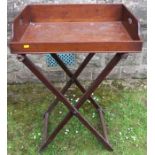 A Georgian mahogany rectangular butler's tray and stand, the tray with three gallery sides and