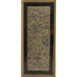 37684 An Oriental embroidered panel, decorated with figures and buildings, 22ins x 9ins