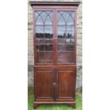 A Georgian mahogany glazed cabinet, raised on a cupboard base, the upper section having astragal