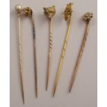 A 15ct gold fox mask stick pin, together with a 9ct gold stick pin, Inniskilling, two set with