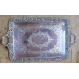 A large silver plated rectangular tray, with engraved decoration, pierced border and a pair of