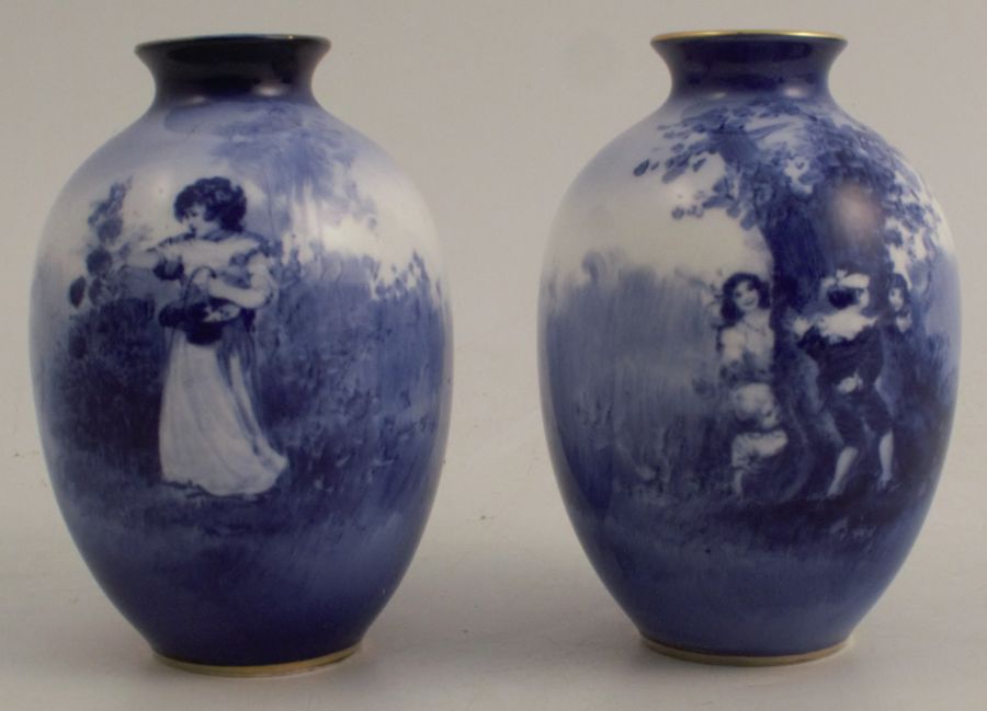 A pair of Royal Doulton blue vases, decorated with children in an all around landscape, height 4ins