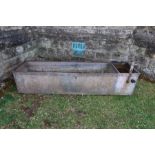 A heavy galvanised riveted and banded trough, width 48ins, depth 18ins , height 12ins
