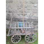 A primitive style wooden dog cart, together with a copper wash dollie, with long wooden handle