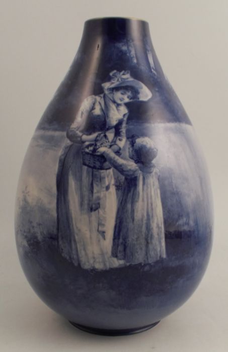 A Royal Doulton blue flambé children's vase, decorated with a young girl and child with basket of